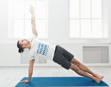 T-Shirt Mockup of a Man Doing a Yoga Pose in Home
