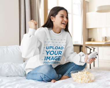 Mockup Featuring a Female Gamer Wearing a Sweatshirt at Home 