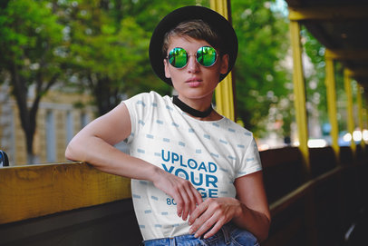T-Shirt Mockup Featuring a Serious Woman Wearing a Sublimated T-Shirt in a Tram