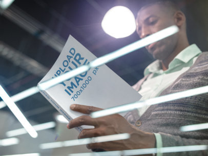 Business Man Reading a Book Standing While Under a White Light Template