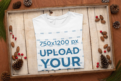 Mockup of a T-Shirt Neatly Folded Inside a Christmas-Decorated Box m160