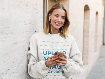 Sweatshirt Mockup Featuring a Young Woman Listening to Music 