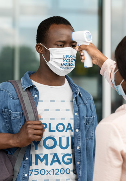 T-Shirt Mockup of a Man with a Face Mask Getting His Temperature Checked