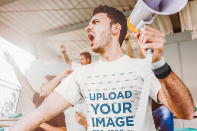 T-Shirt Mockup of a Man Watching a Soccer Match Holding a Megaphone