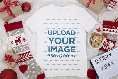 Mockup of a Round-Neck Tee Laid on a Christmas-Decorated Surface