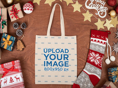 Mockup of a Tote Bag Placed on a Wooden Surface with Christmas Items m34