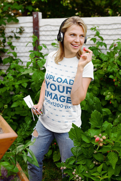 T-Shirt Mockup Featuring a Female Gardener Eating a Berry 