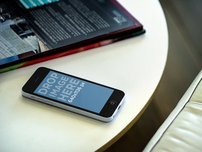 Mockup of an iPhone 5C in a Waiting Room by Some Magazines