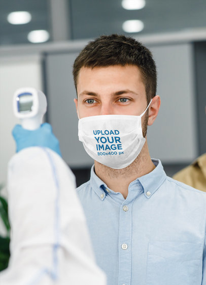 Face Mask Mockup Featuring a Man Getting His Temperature Checked 