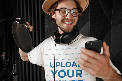 T-Shirt Mockup of a Happy Male Singer Checking His Phone 40166-r-el2