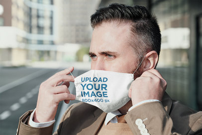 Mockup of a Serious Man Putting a Face Mask on 