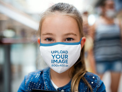 Face Mask Mockup Featuring a Little Girl Staring into the Camera