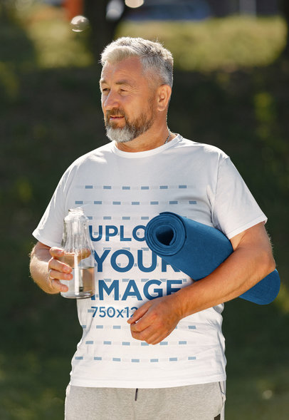 T-Shirt Mockup of a Senior Man About to Do Yoga