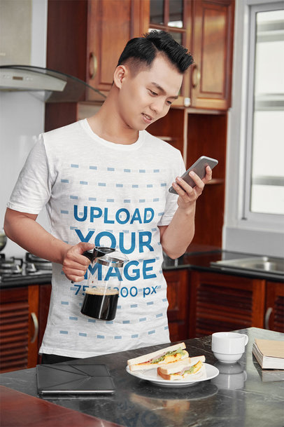 T-Shirt Mockup of a Man Having Breakfast at His Kitchen