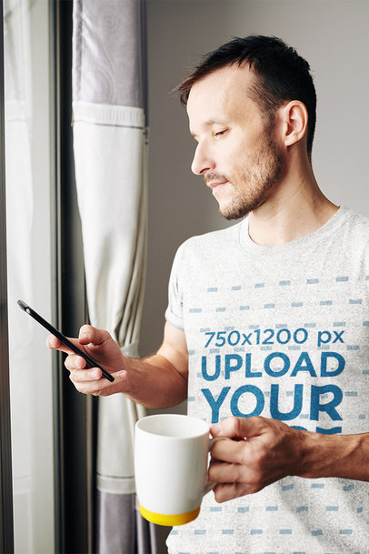 Heather Tee Mockup of a Man Checking His Phone at Home 