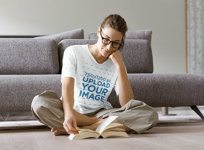 Mockup of a Woman with a Heather Tee Reading on the Floor