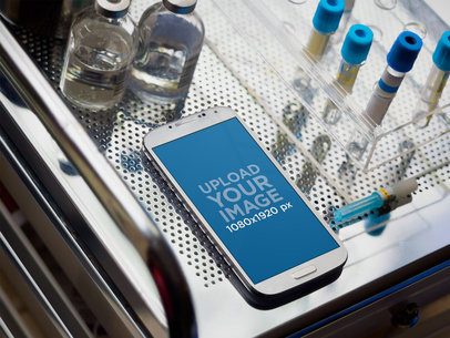 Mockup of a Samsung Galaxy Placed on a Medical Cabinet by Glass Bottles