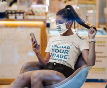 T-Shirt Mockup of a Young Woman Wearing a Face Mask and Checking Her Phone 41377-r-el2
