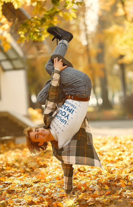T-Shirt Mockup of a Man Breakdancing on Dry Leaves