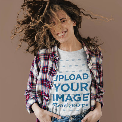 Mockup of a Happy Woman Wearing a Heather T-Shirt Against a Plain Backdrop 