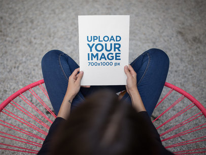 Mockup of a Girl Holding a Catalog While Crossing Her Legs a14650