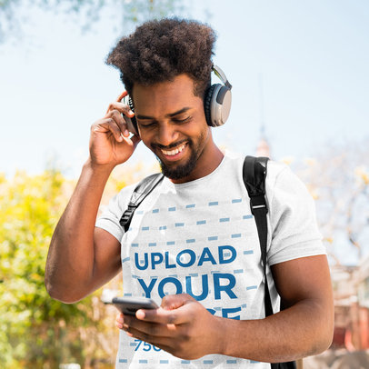 Heather T-Shirt Mockup of a Happy Man Listening to Music on the Street