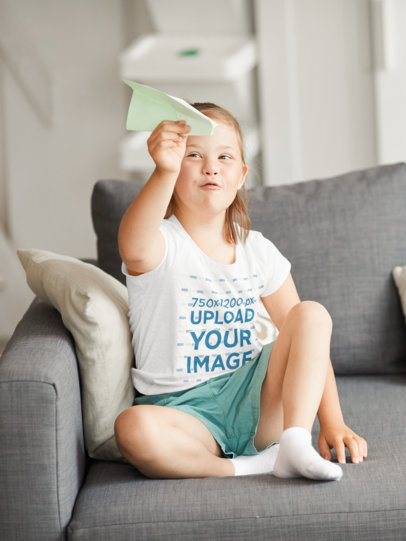 T-Shirt Mockup of a Girl Playing with a Paper Plane