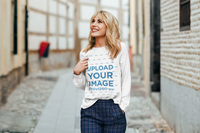 Long-Sleeve Tee Mockup Featuring a Woman Walking on a Tiny Street