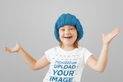 Mockup of a Happy Little Girl Wearing a T-Shirt at a Studio