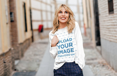 Mockup of a Happy Woman with a Long-Sleeve Tee Walking in the City