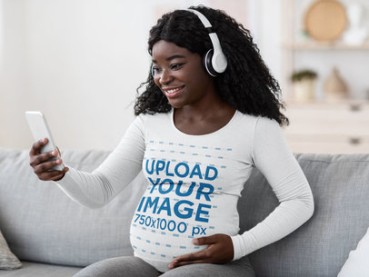 Mockup of a Pregnant Woman with a Long-Sleeve Tee Taking a Selfie