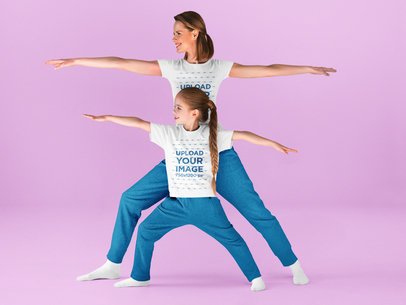 T-Shirt Mockup of a Woman Doing Yoga With Her Daughter in a Studio
