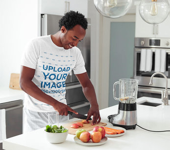 Heather T-Shirt Mockup of a Man in His Pajamas Cooking 