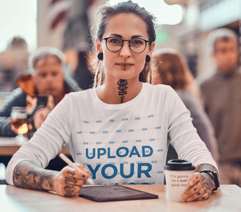 Long Sleeve Tee Mockup of an Edgy Designer Working While Having a Coffee
