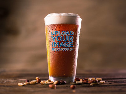 Mockup of a Pint of Red Beer Standing on a Wooden Surface Near Peanuts
