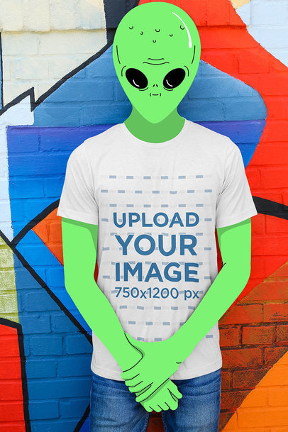 Illustrated Mockup of a Green Alien Wearing a T-Shirt in an Urban Scenario