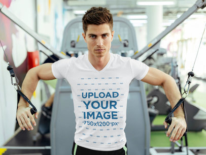 V-Neck T-Shirt Mockup of a Man Training Chest at the Gym