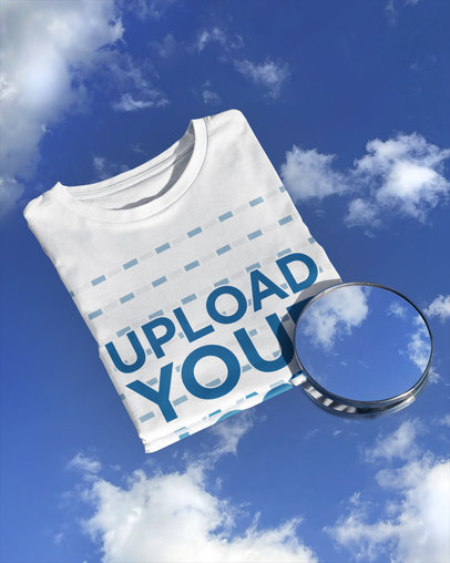 Mockup of a Folded T-Shirt Featuring a Mirror Reflecting the Sky