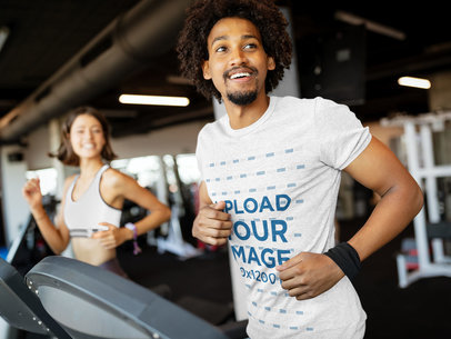 Heather Tee Mockup of a Fit Man Jogging on a Treadmill 