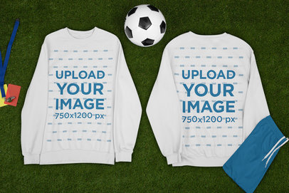 Mockup of Two Sweatshirts Lying by a Soccer Ball m387