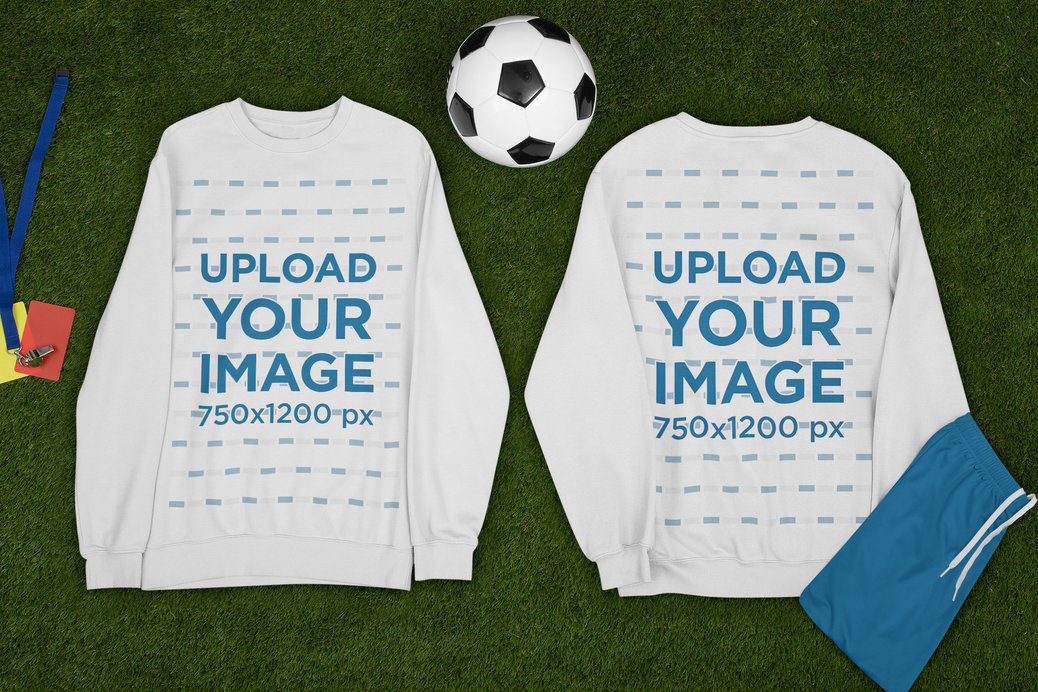 Mockup of Two Sweatshirts Lying by a Soccer Ball