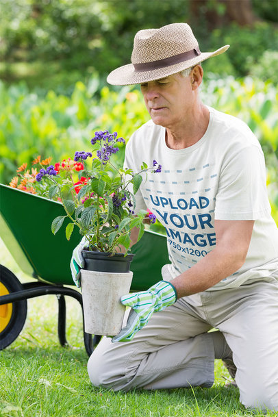 T-Shirt Mockup Featuring a Senior Man Planting Some Flowers