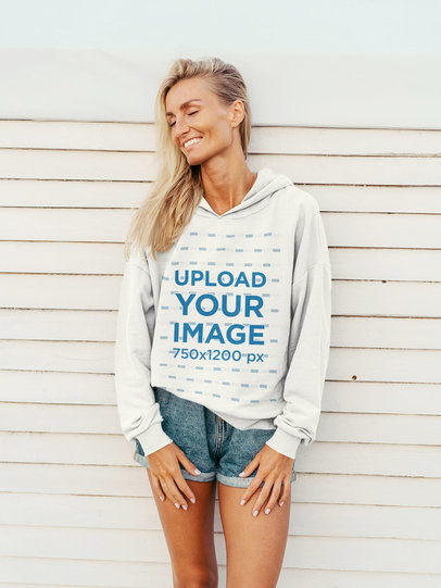 Pullover Hoodie Mockup of a Happy Woman Leaning on a White Wall 