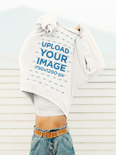 Mockup of a Woman Taking off a Hoodie 