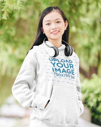 Mockup of a Smiling Teenager Wearing a Heathered Hoodie