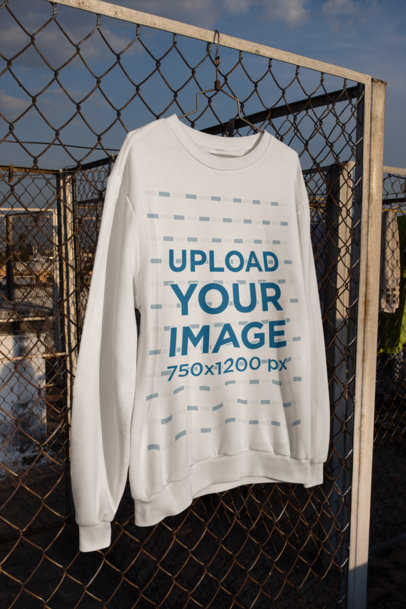 Mockup of a Crewneck Sweatshirt Hangin on a Wire-Mesh Fence m442
