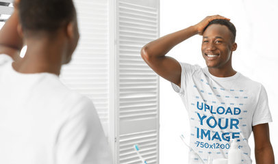 T-Shirt Mockup of a Happy Man Looking in the Mirror 