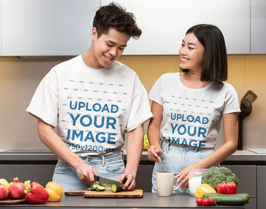 T-Shirt Mockup Featuring a Young Couple Cooking at Home 