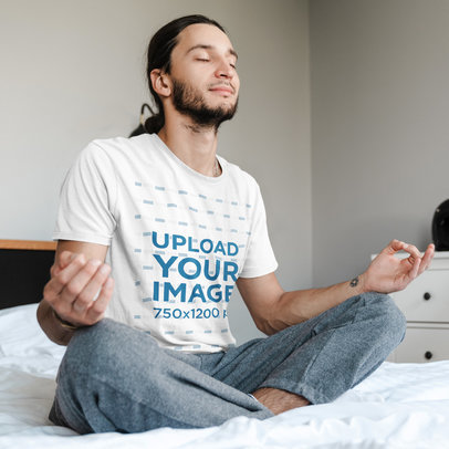 T-Shirt Mockup Featuring a Man with a Ponytail Meditating in His Bed