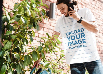 T-Shirt Mockup of a Man Watering Some Plants